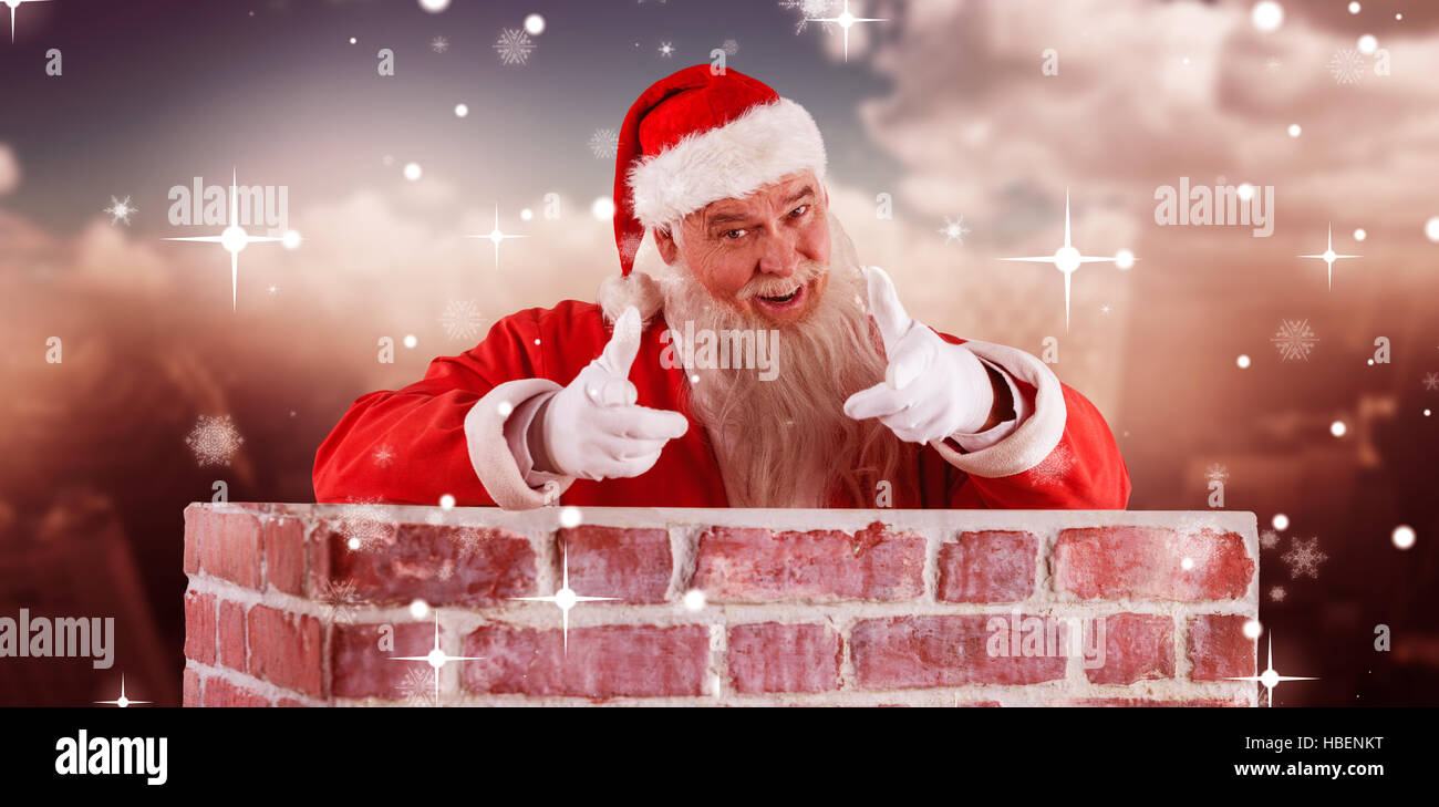 Composite image of portrait of happy santa claus making hand gesture over wall Stock Photo