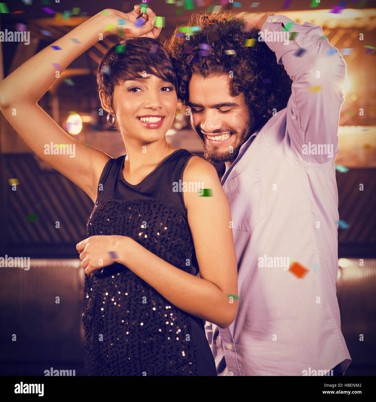 Composite image of cute couple dancing together on dance floor Stock Photo