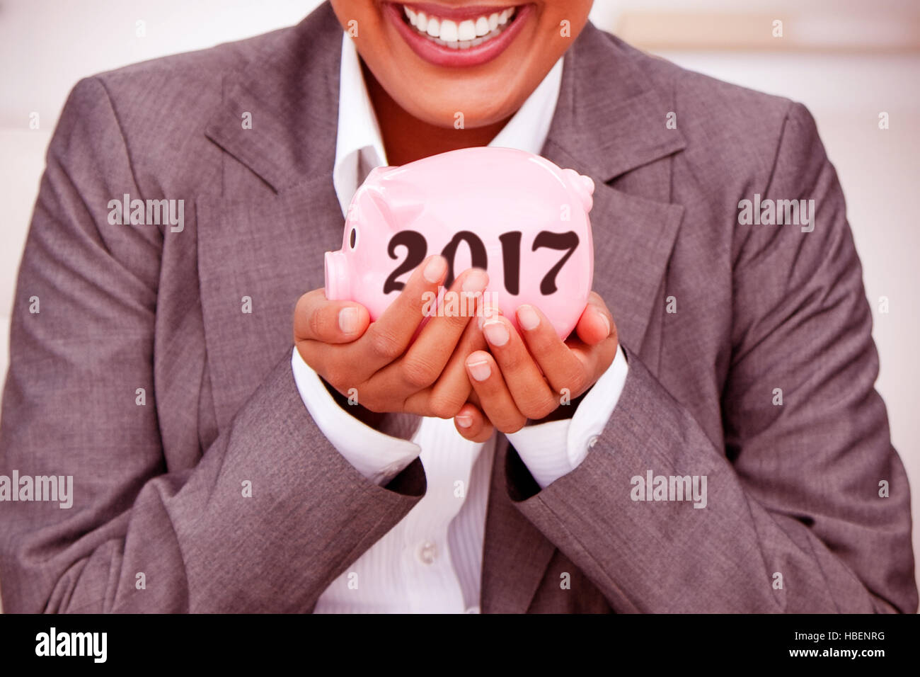 Composite image of close up of a smiling businesswoman holding a piggybank Stock Photo