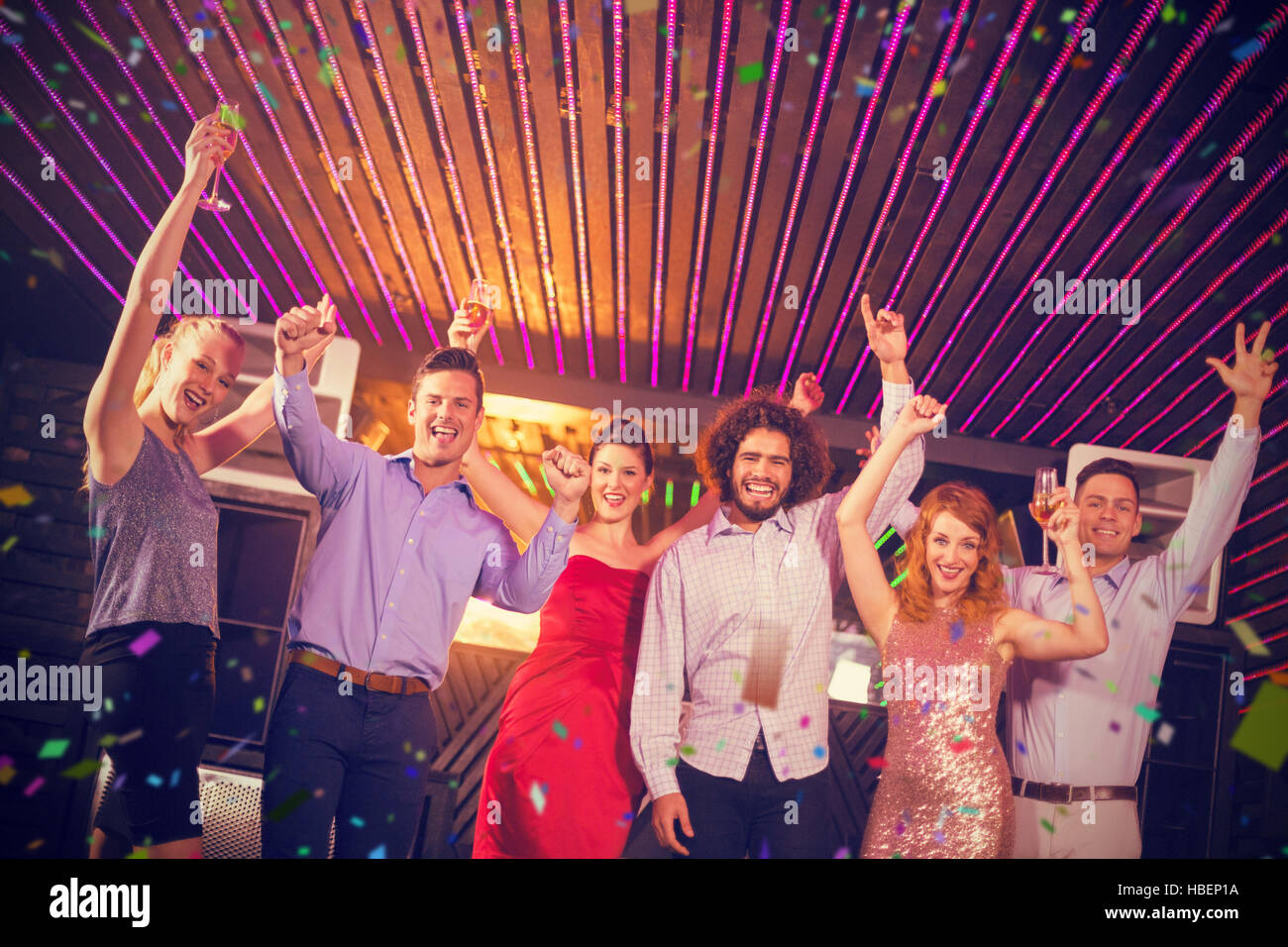 Composite image of smiling friends dancing on dance floor Stock Photo