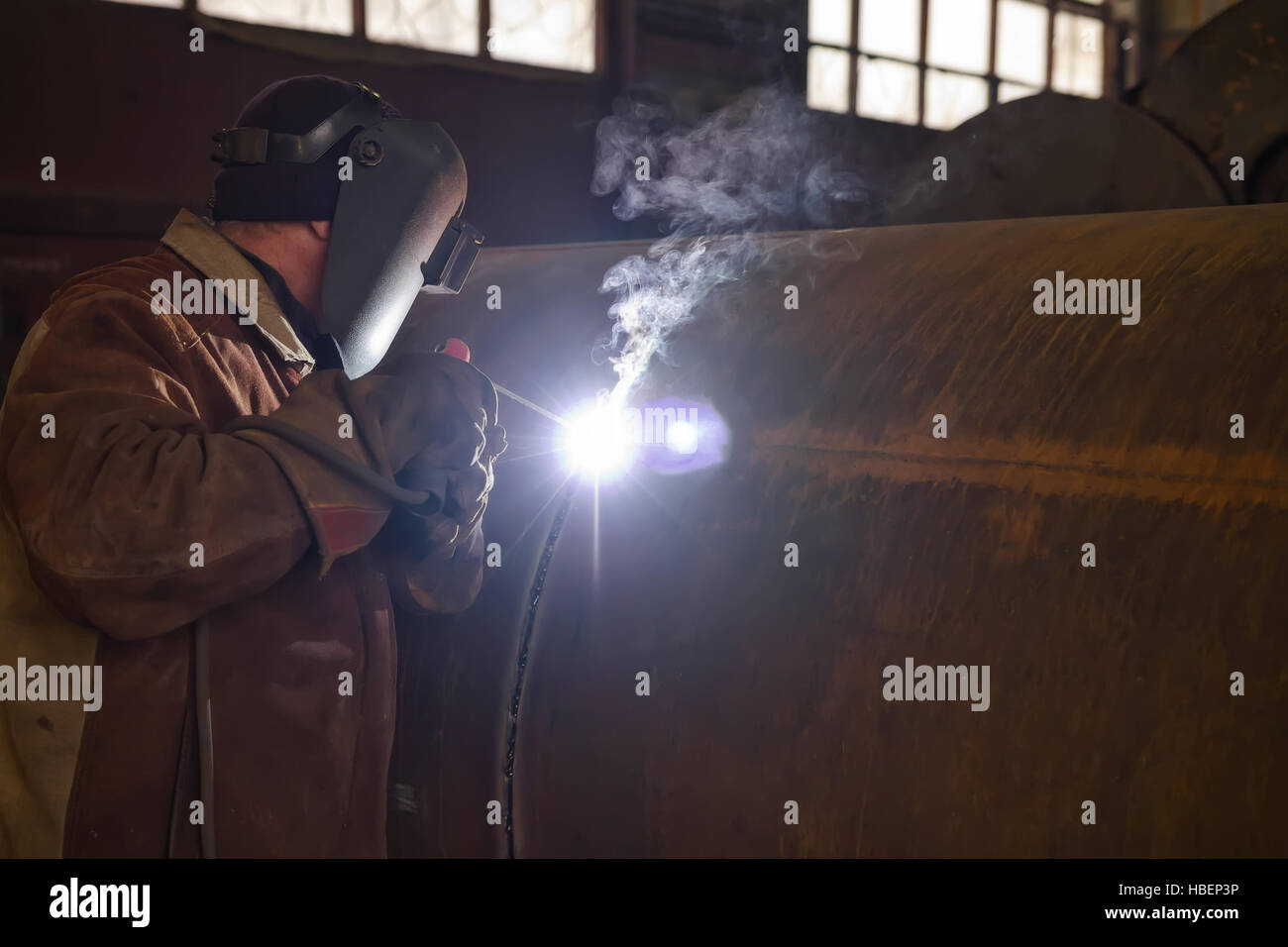 welder performs welding large diameter pipe Stock Photo