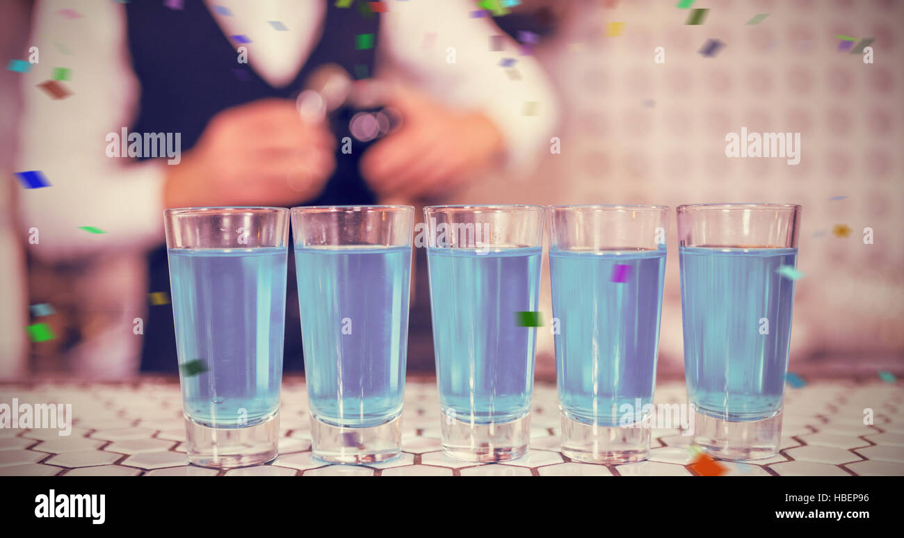 Composite image of glasses of blue lagoon drinks on bar counter Stock Photo