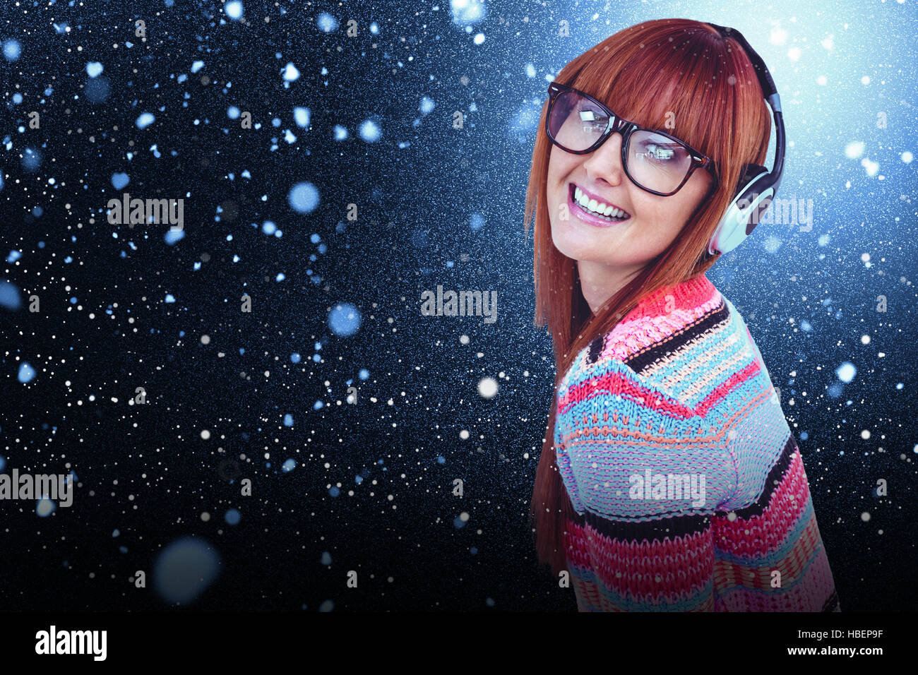 Composite image of smiling hipster woman listening music with headphones Stock Photo
