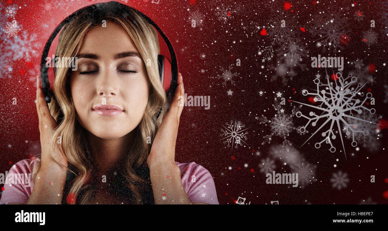 Composite image of close up of a woman listening to music Stock Photo