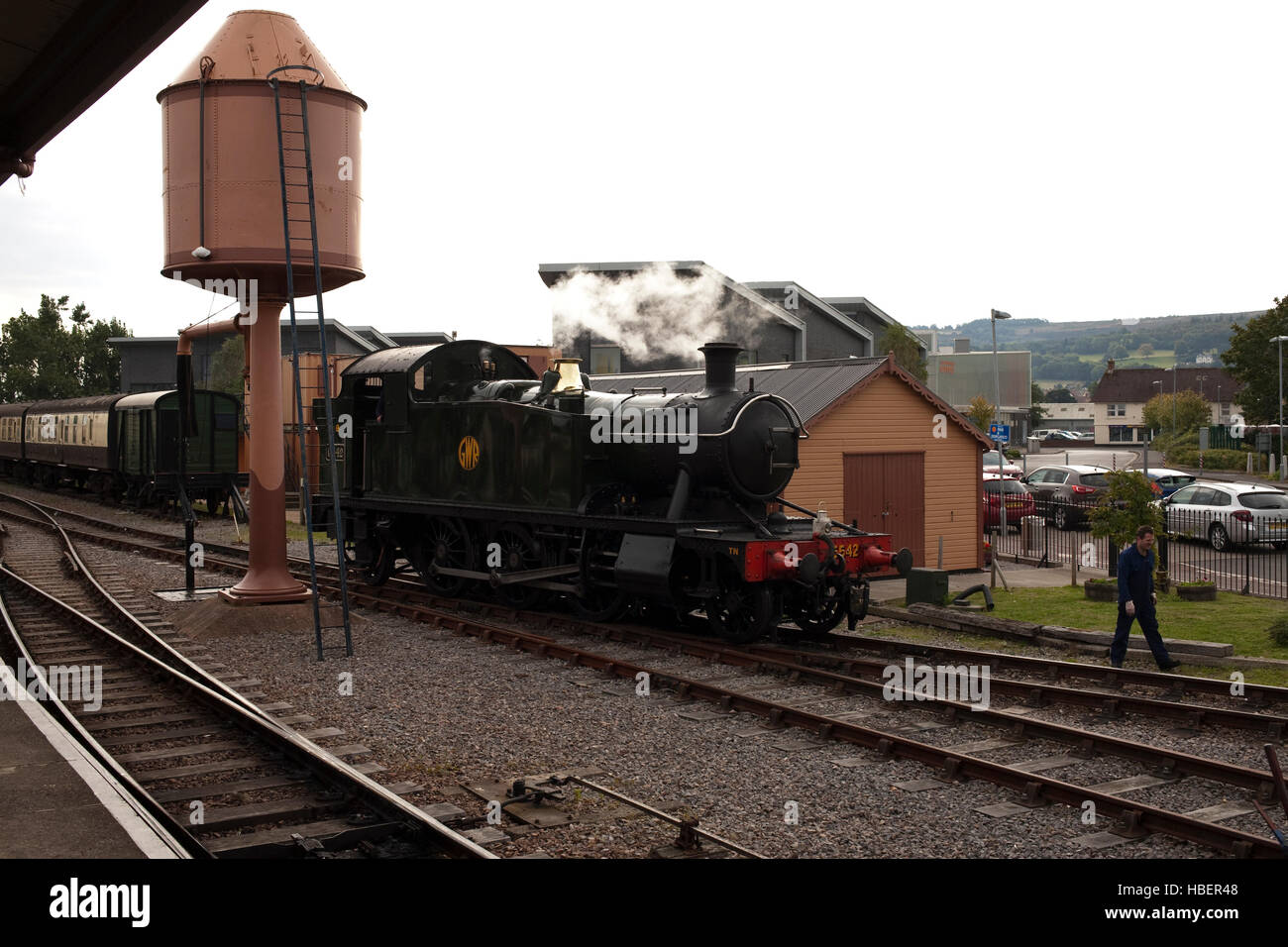 steam locomotive coming away from the water tower at minehead railway station Stock Photo