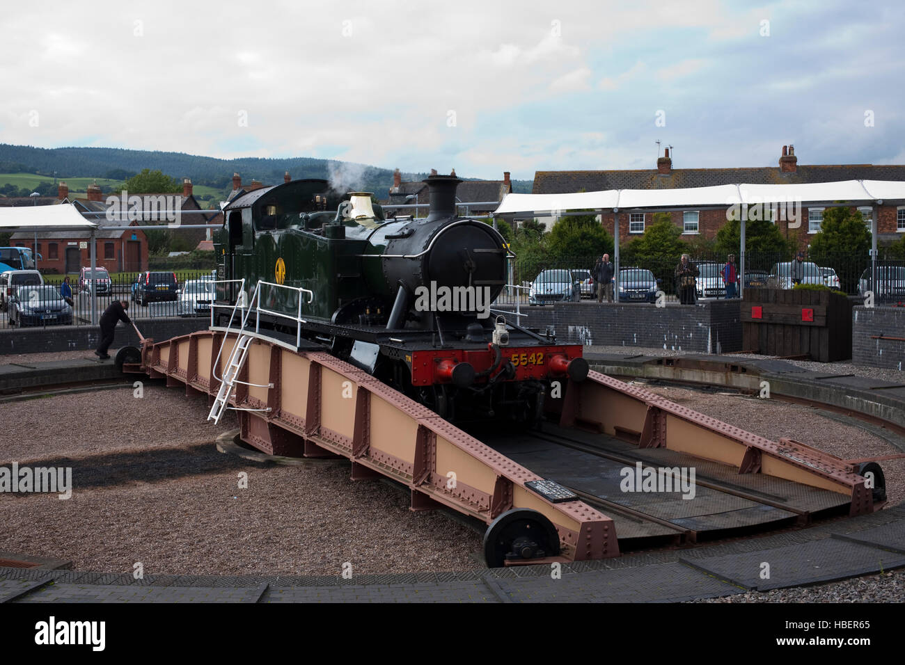 steam locomotive being turned on a manual railway turntable on the Minehead line Stock Photo
