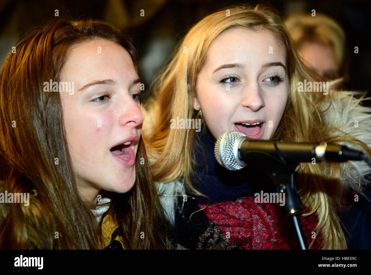 Members of a local singing group performing at an outdoor Christmas Market, Grayshott, Hampshire, UK. Stock Photo