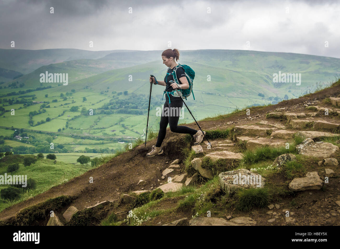 Female on rocky hill path, Peak District, Derbyshire, UK. Stock Photo