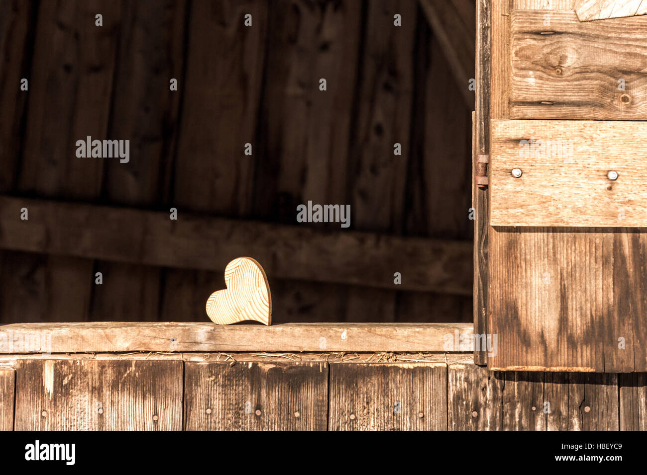 Wooden heart at the barn Stock Photo