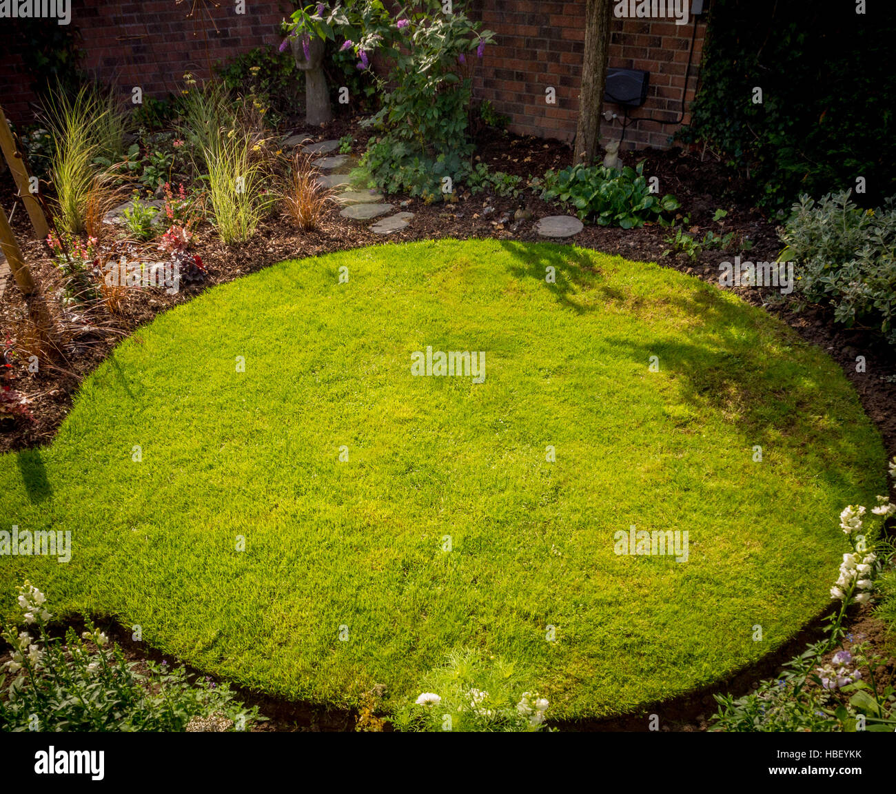 Circular lawn in british garden Stock Photo