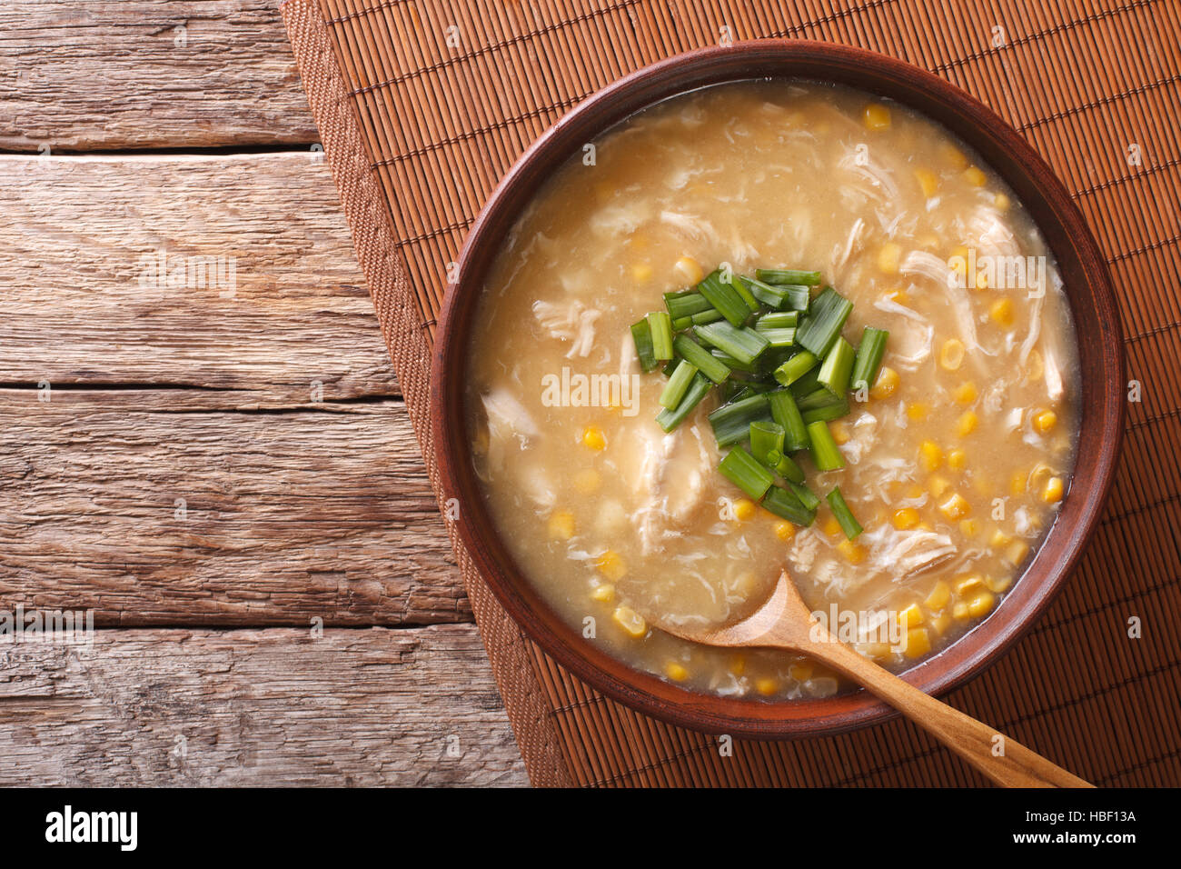 Chinese corn and chicken soup in a bowl macro on the table. horizontal view from above Stock Photo