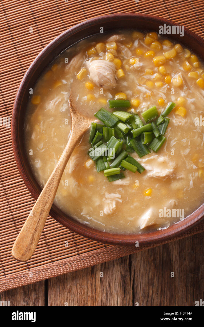 Chinese thick corn soup with chicken close up in a bowl. vertical view from above Stock Photo