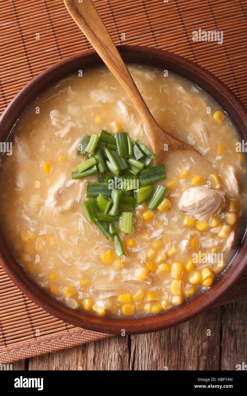 Chinese corn and chicken soup in a bowl macro on the table. vertical view from above Stock Photo
