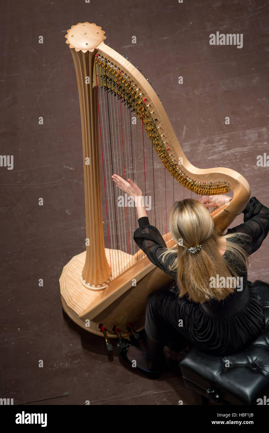 A young girl playing the harp during concert at musical theater Stock Photo