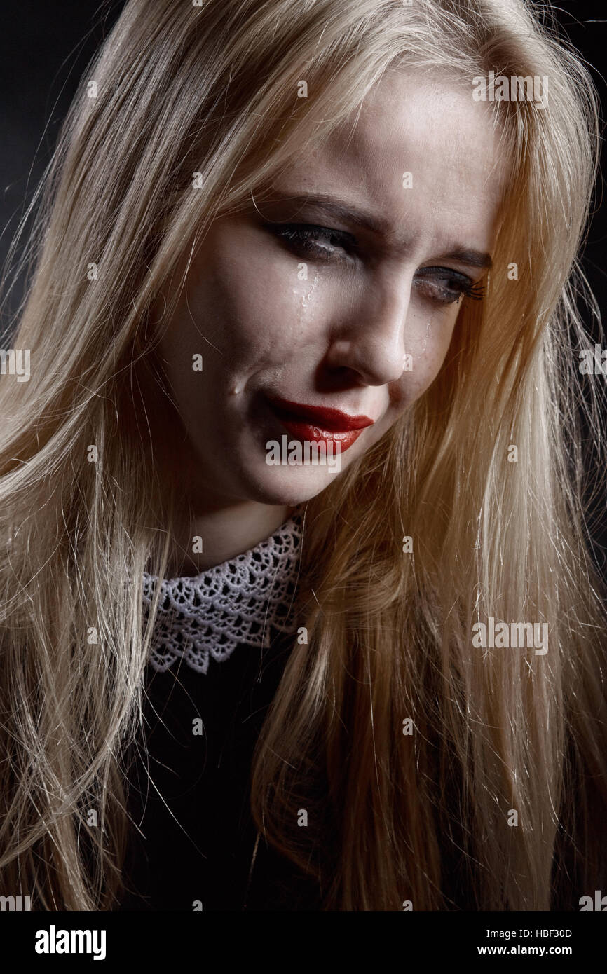 sad girl crying on black background Stock Photo - Alamy