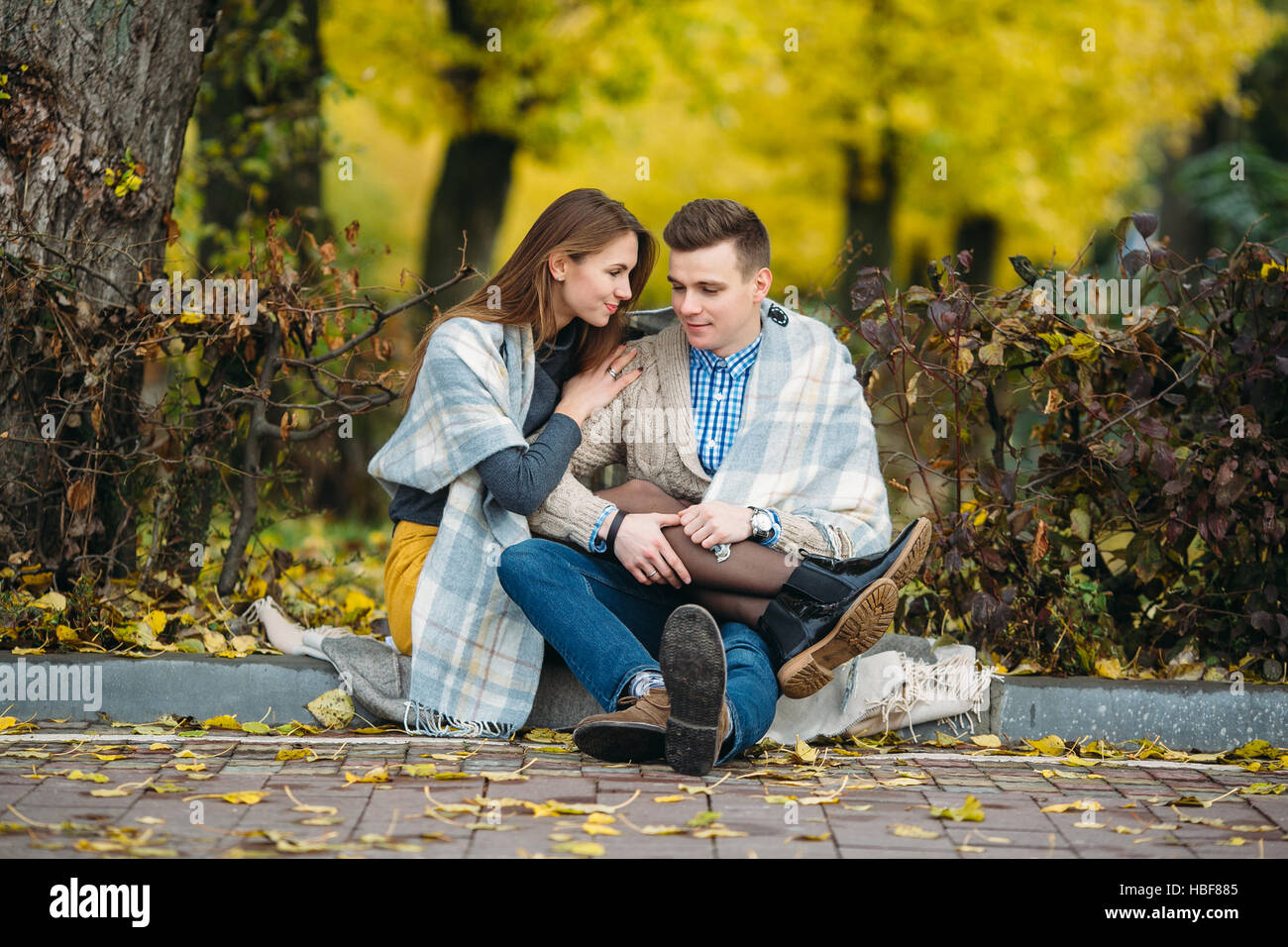 Young couple at the park in autumn season Stock Photo - Alamy