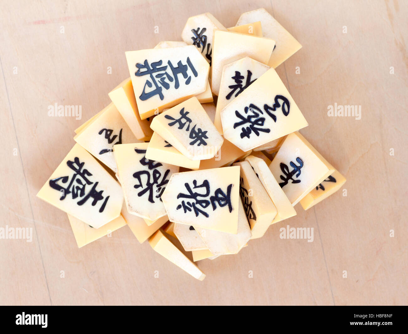 A pile of the Japanese chess pieces called Shogi, also known as a starting postion on a game called Shogi Kuzushi Stock Photo