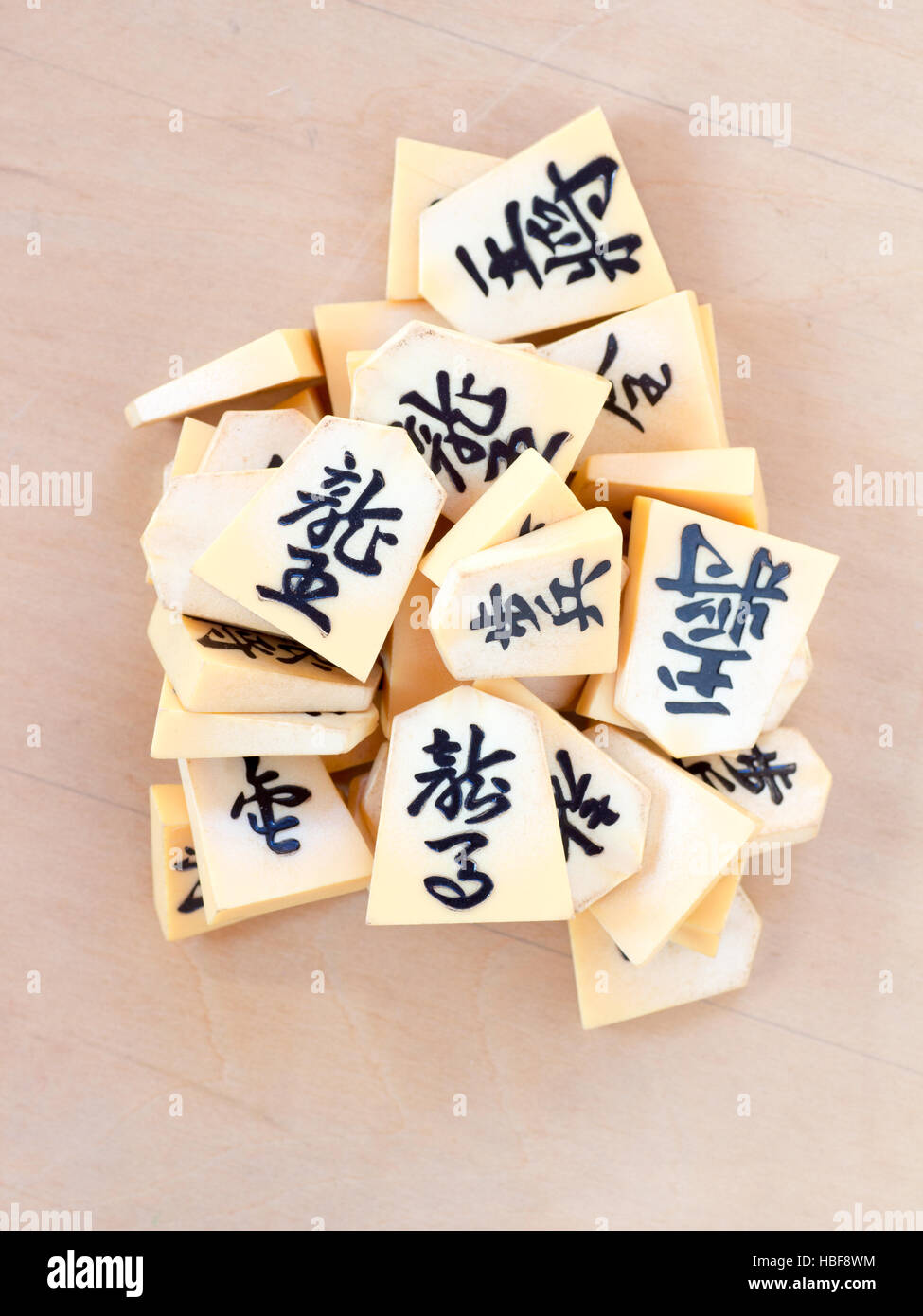 A pile of the Japanese chess pieces called Shogi, also known as a starting postion on a game called Shogi Kuzushi Stock Photo