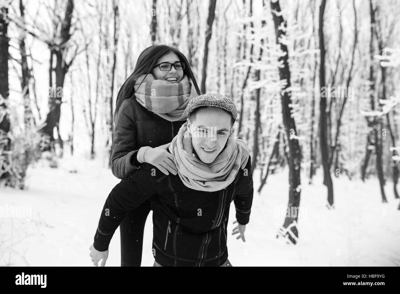 Happy couple playful together in snow park Stock Photo - Alamy