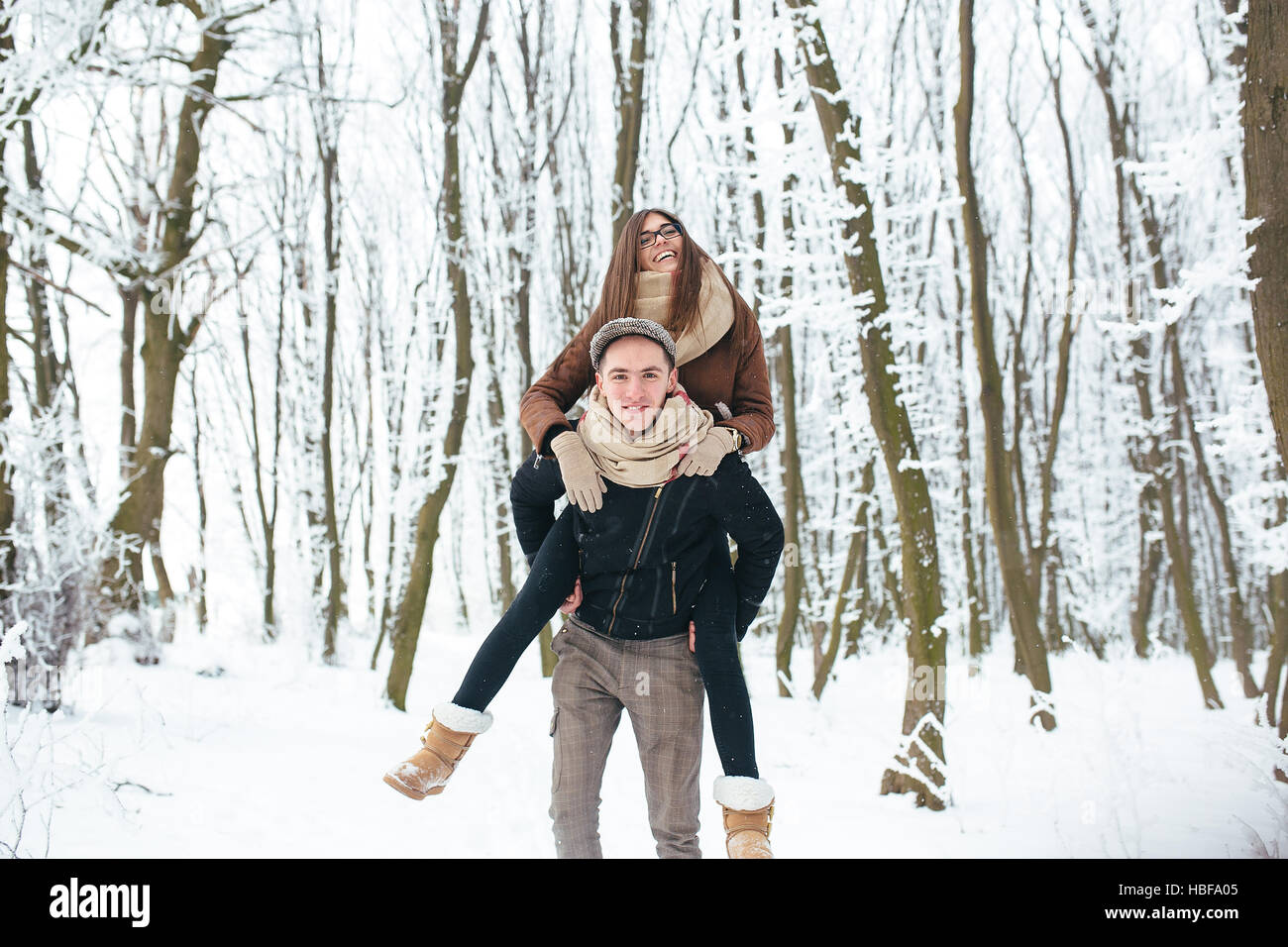 Happy couple playful together in snow park Stock Photo - Alamy