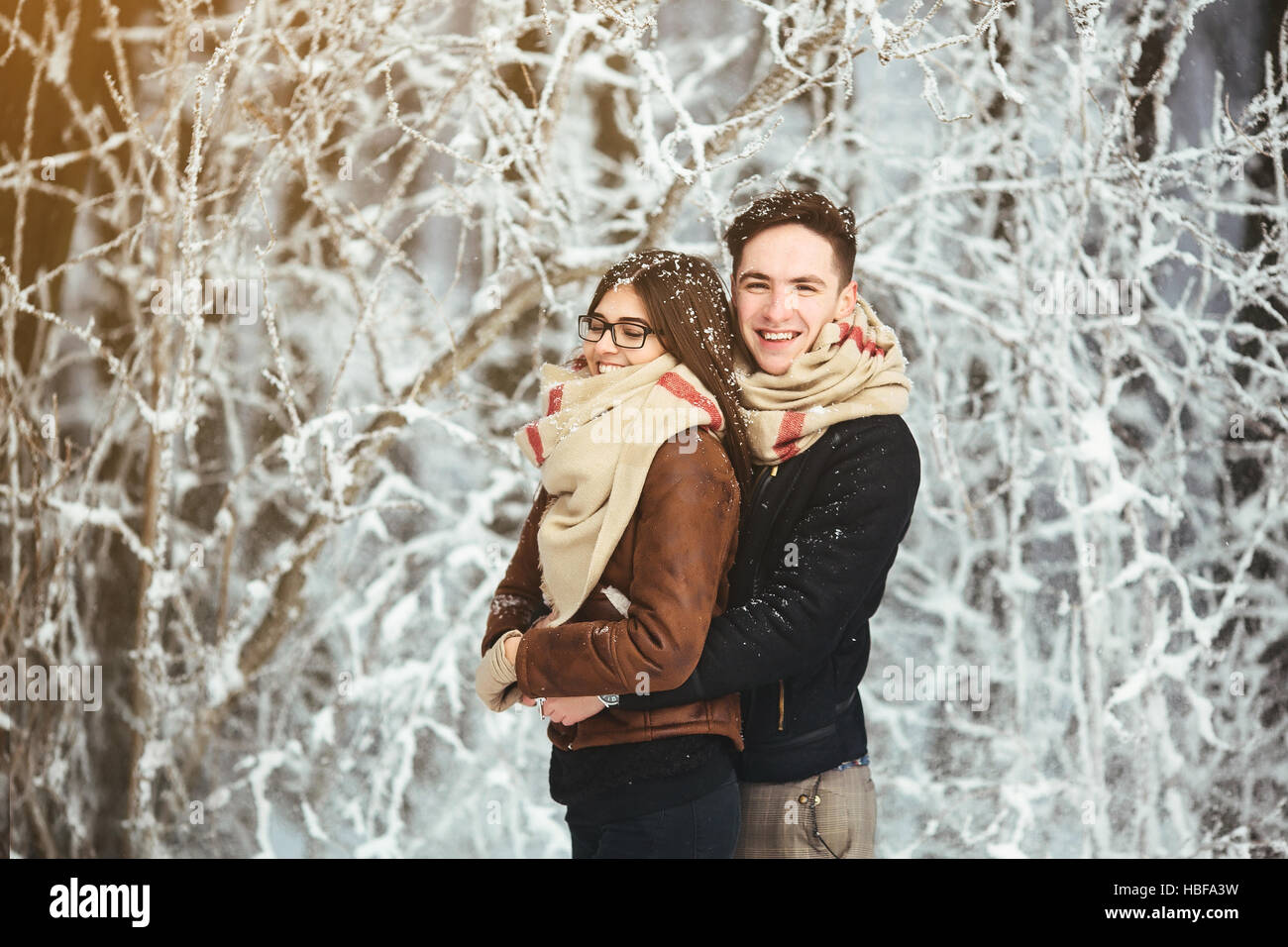 Happy couple in snow park Stock Photo - Alamy