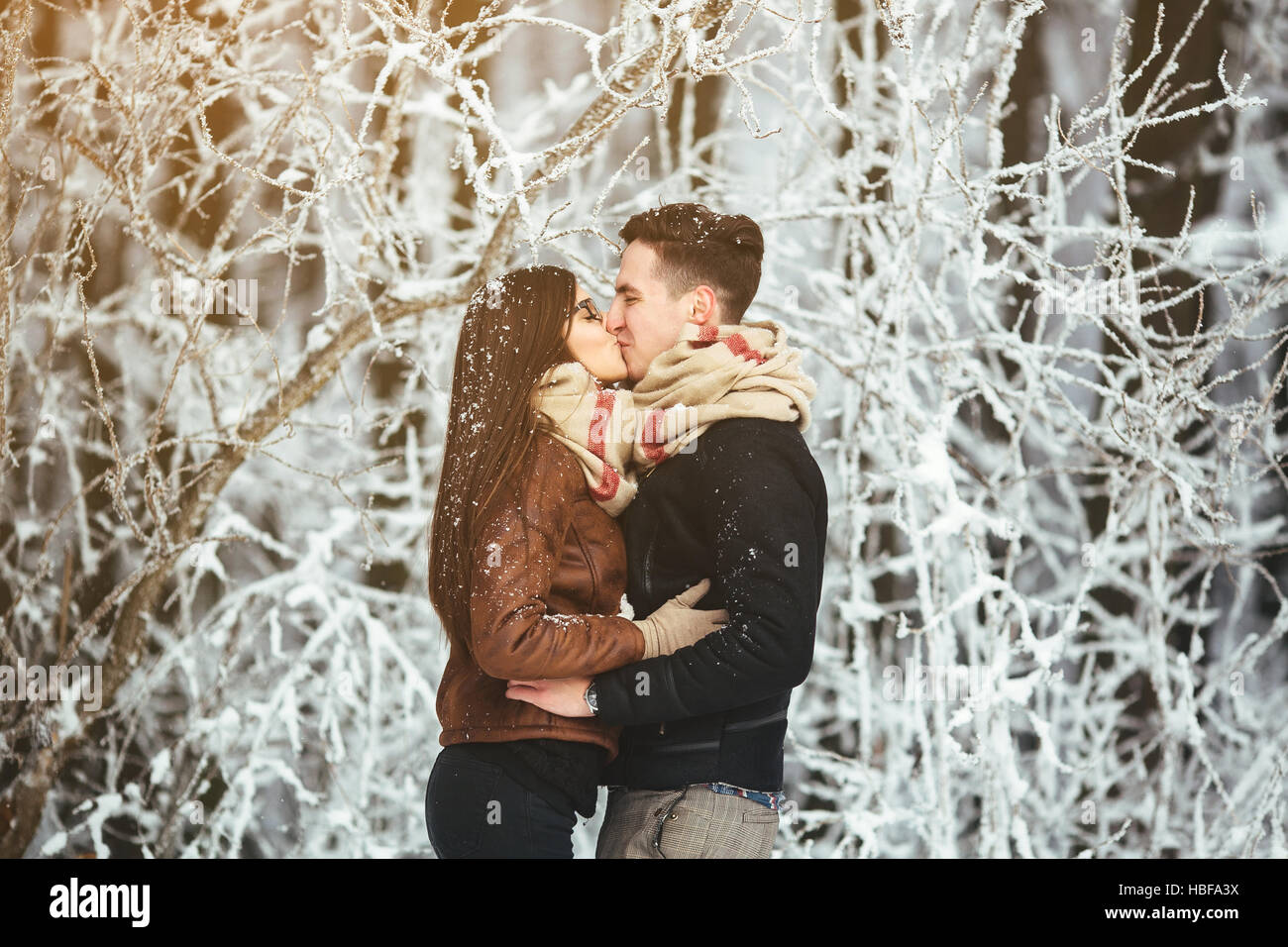 Happy couple in snow park Stock Photo - Alamy