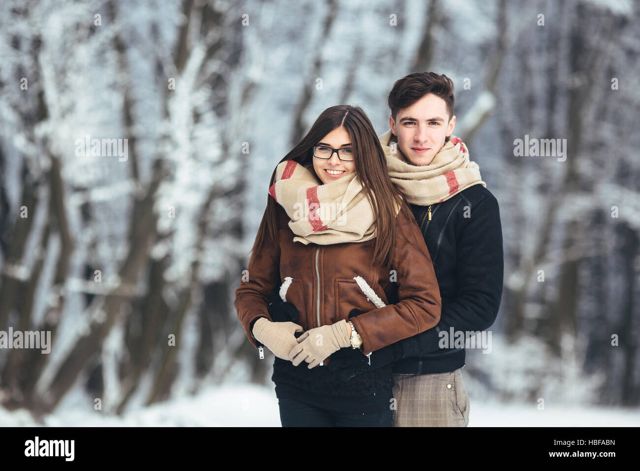 Happy couple in snow park Stock Photo - Alamy