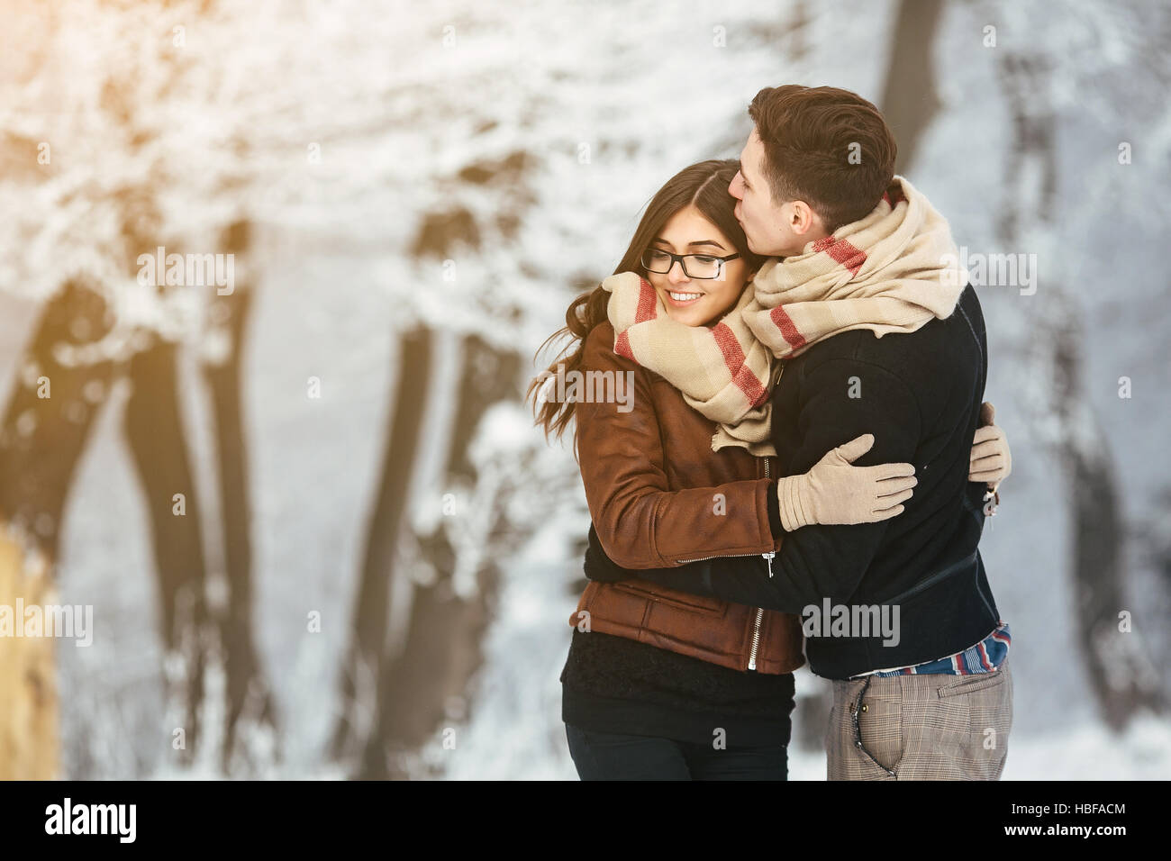 Happy couple in snow park Stock Photo - Alamy