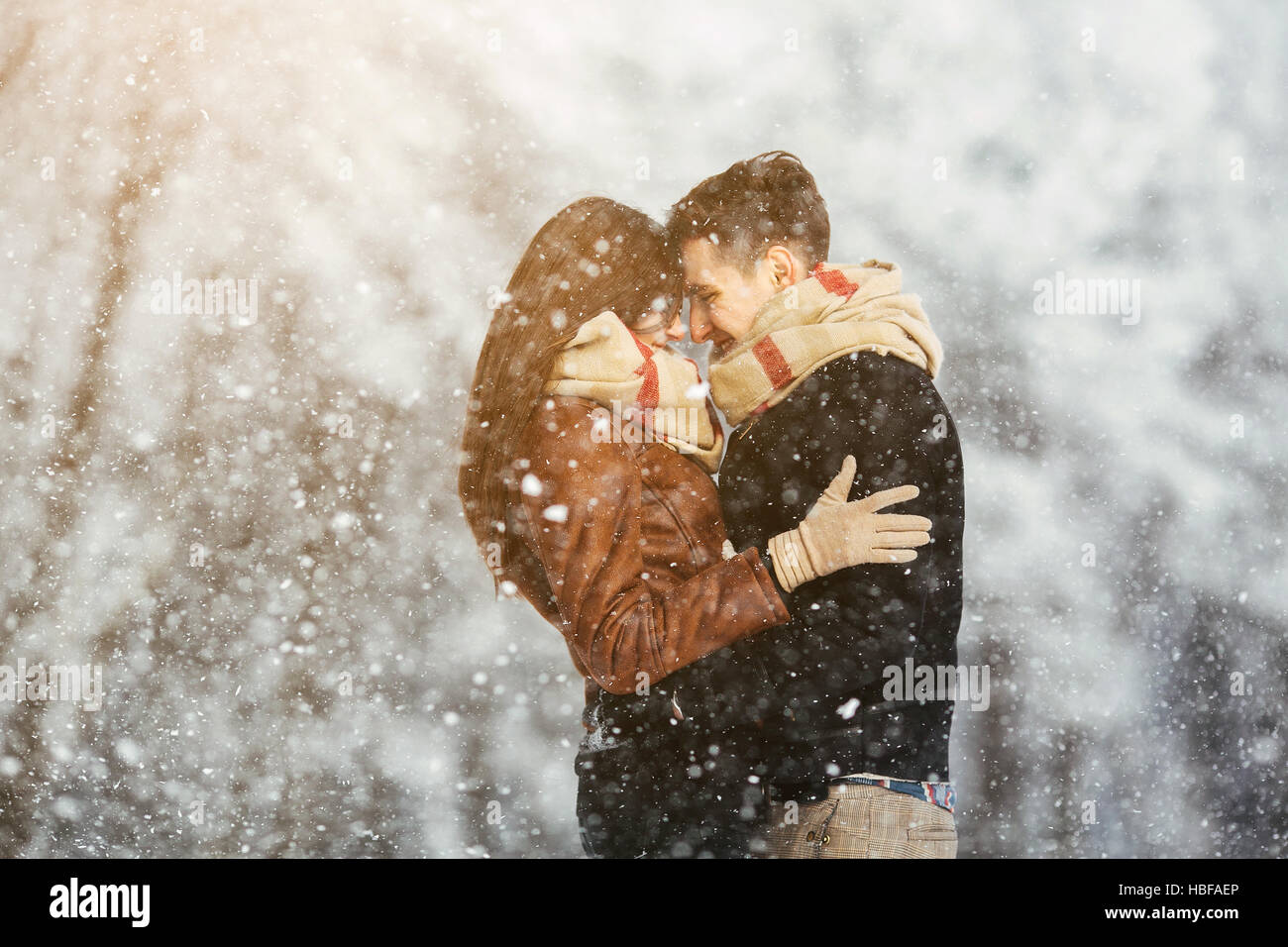 Happy couple in snow park Stock Photo - Alamy