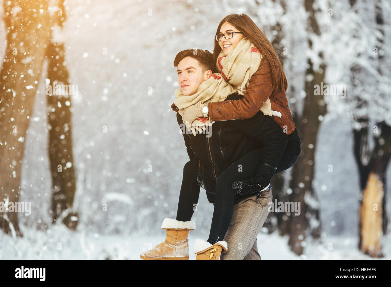 Happy couple playful together in snow park Stock Photo - Alamy