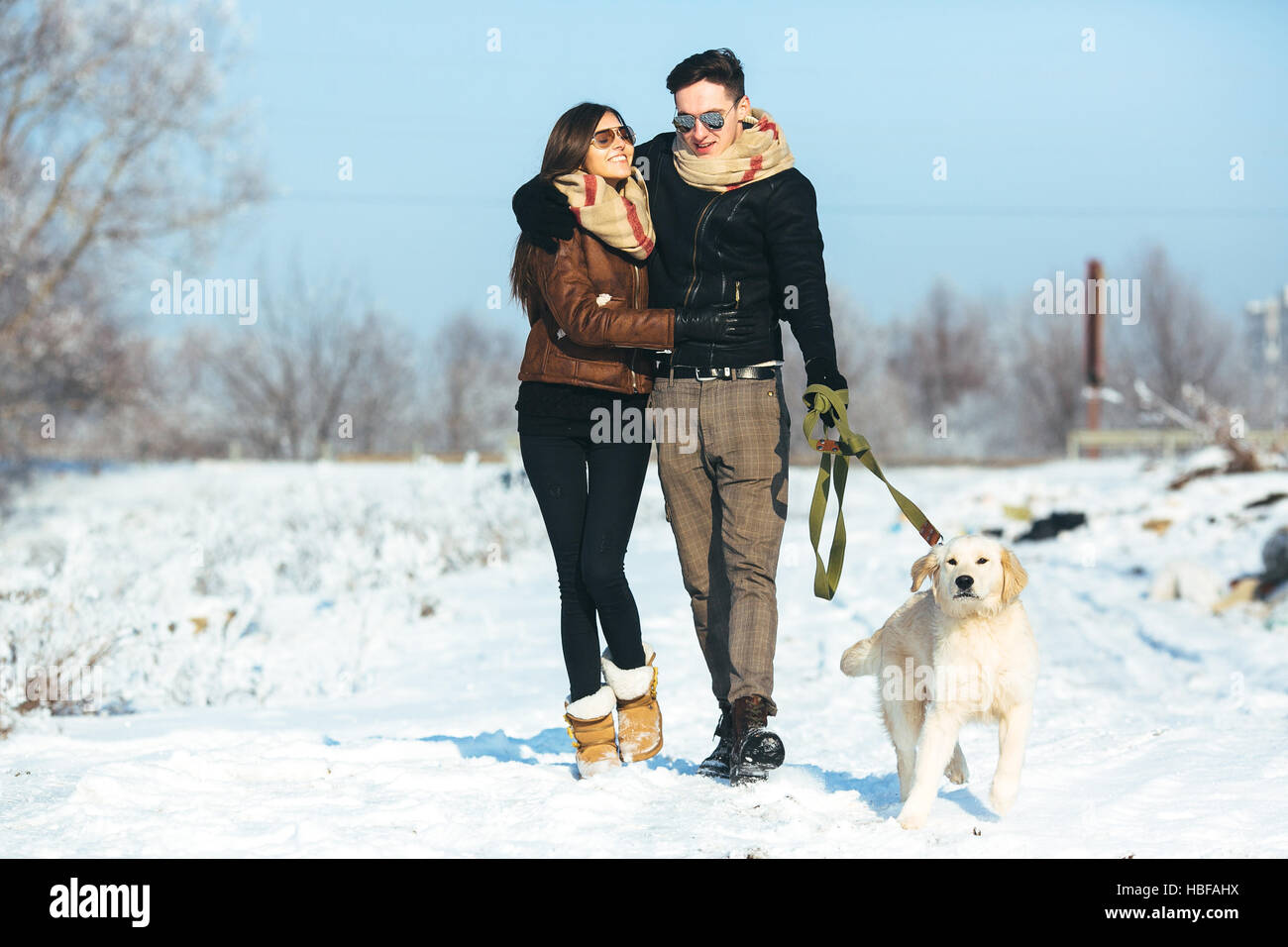 Young couple in love walking with dog Stock Photo - Alamy