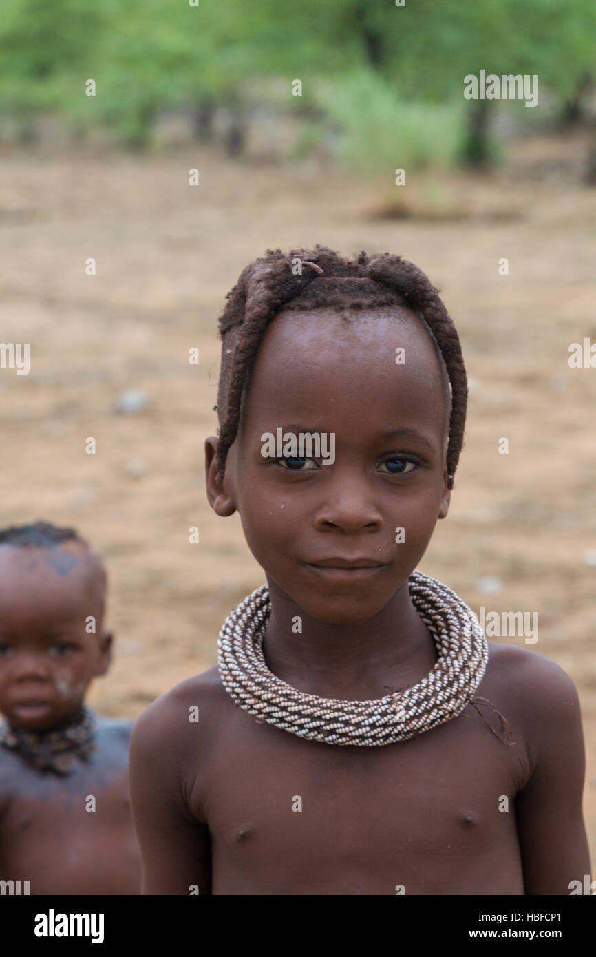 Portrait of a young kid from the Himba tribe, Namibia Stock Photo