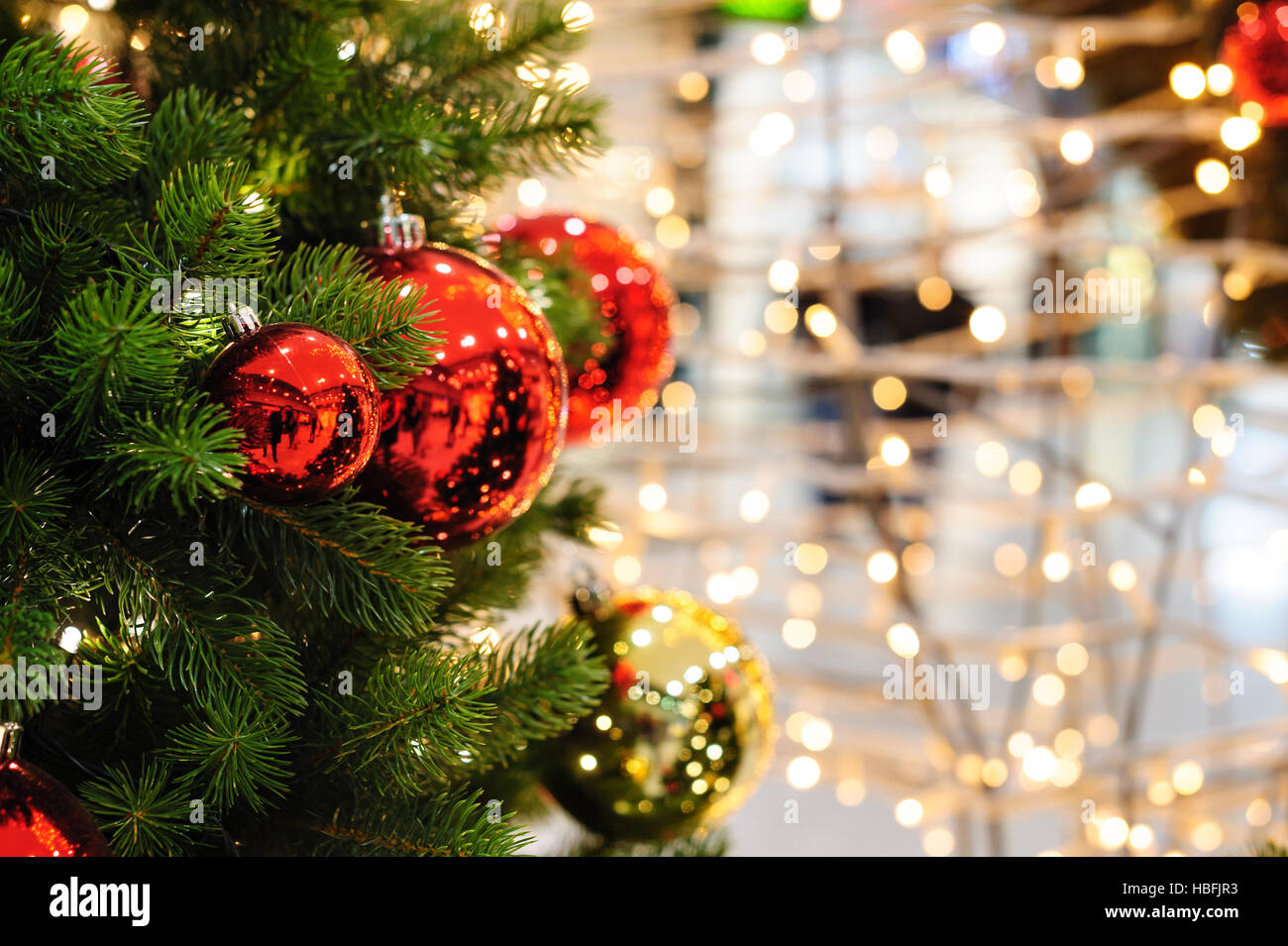 Toy red balls on the Christmas tree Stock Photo