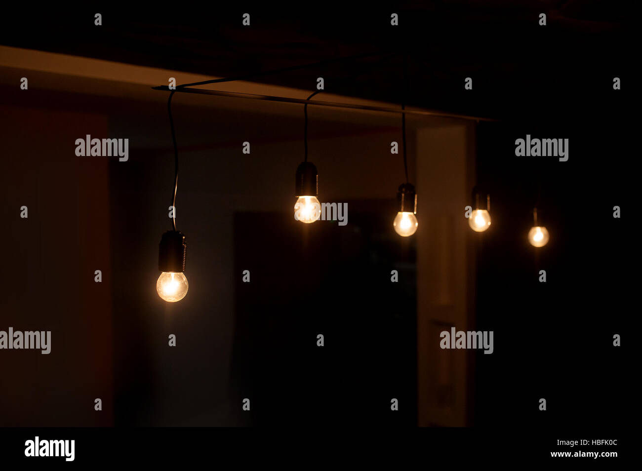 five included light bulbs in a dark room Stock Photo Alamy