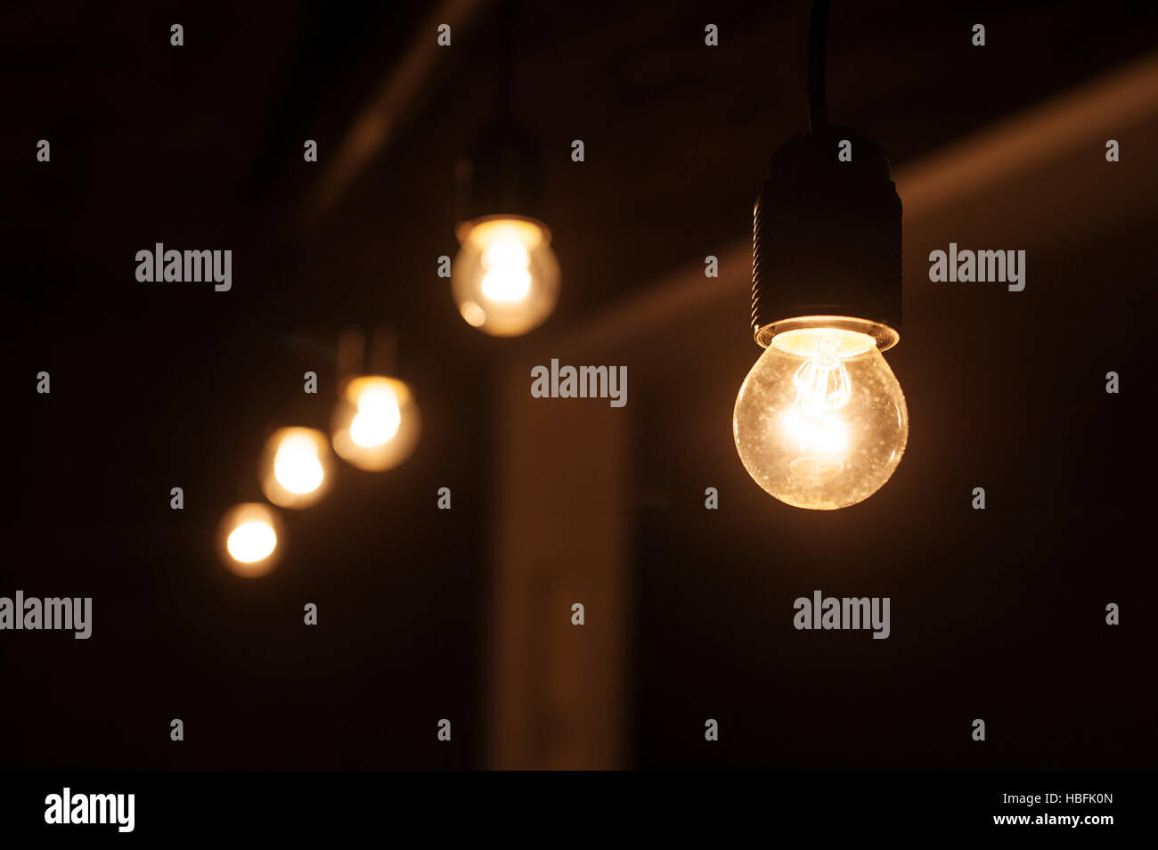 five included light bulbs in a dark room Stock Photo Alamy