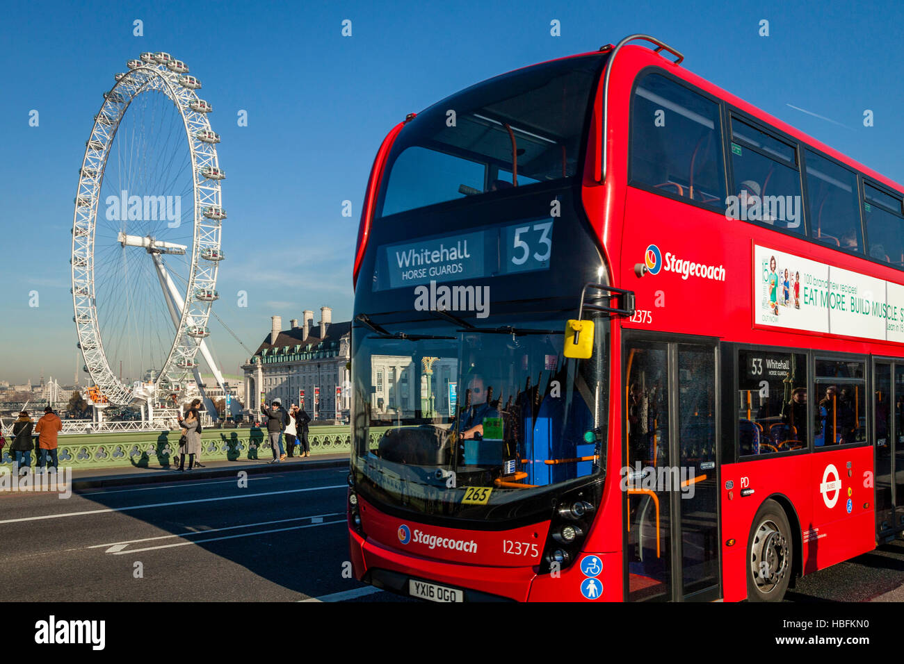 A London Bus Crossing Westminster Bridge With The London Eye In The Backround, London, England Stock Photo