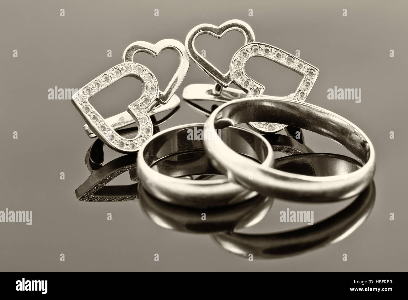 gold wedding rings and earrings Stock Photo