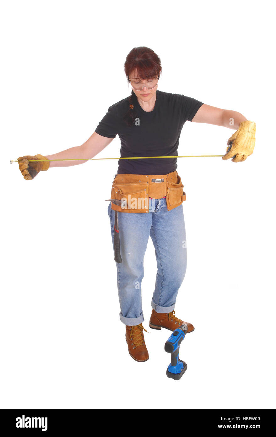 A handy woman measuring for work. Stock Photo