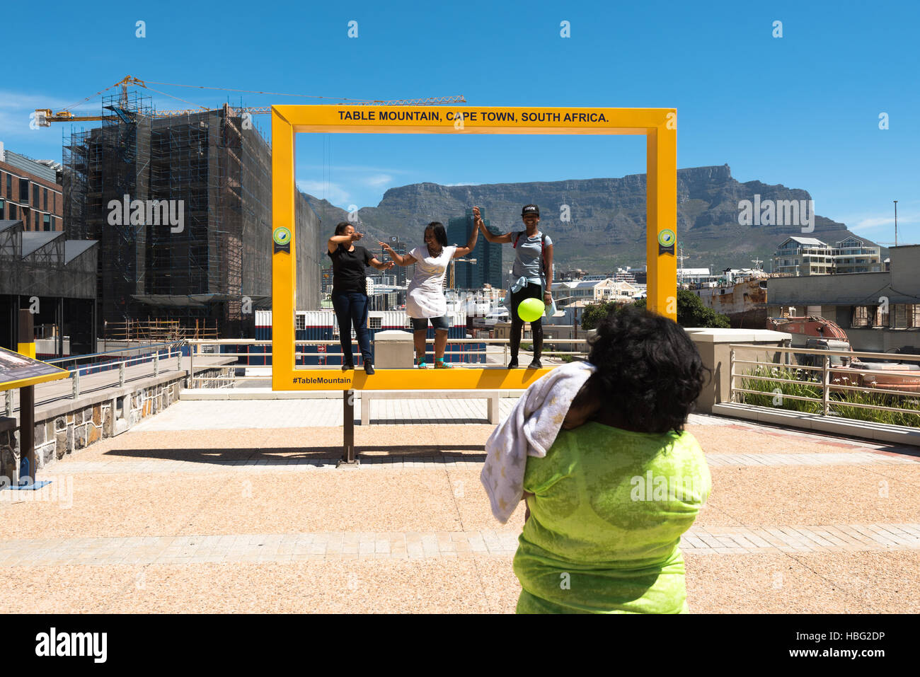 People having fun at the Table Mountain photospot at the Waterfront in Cape Town Stock Photo