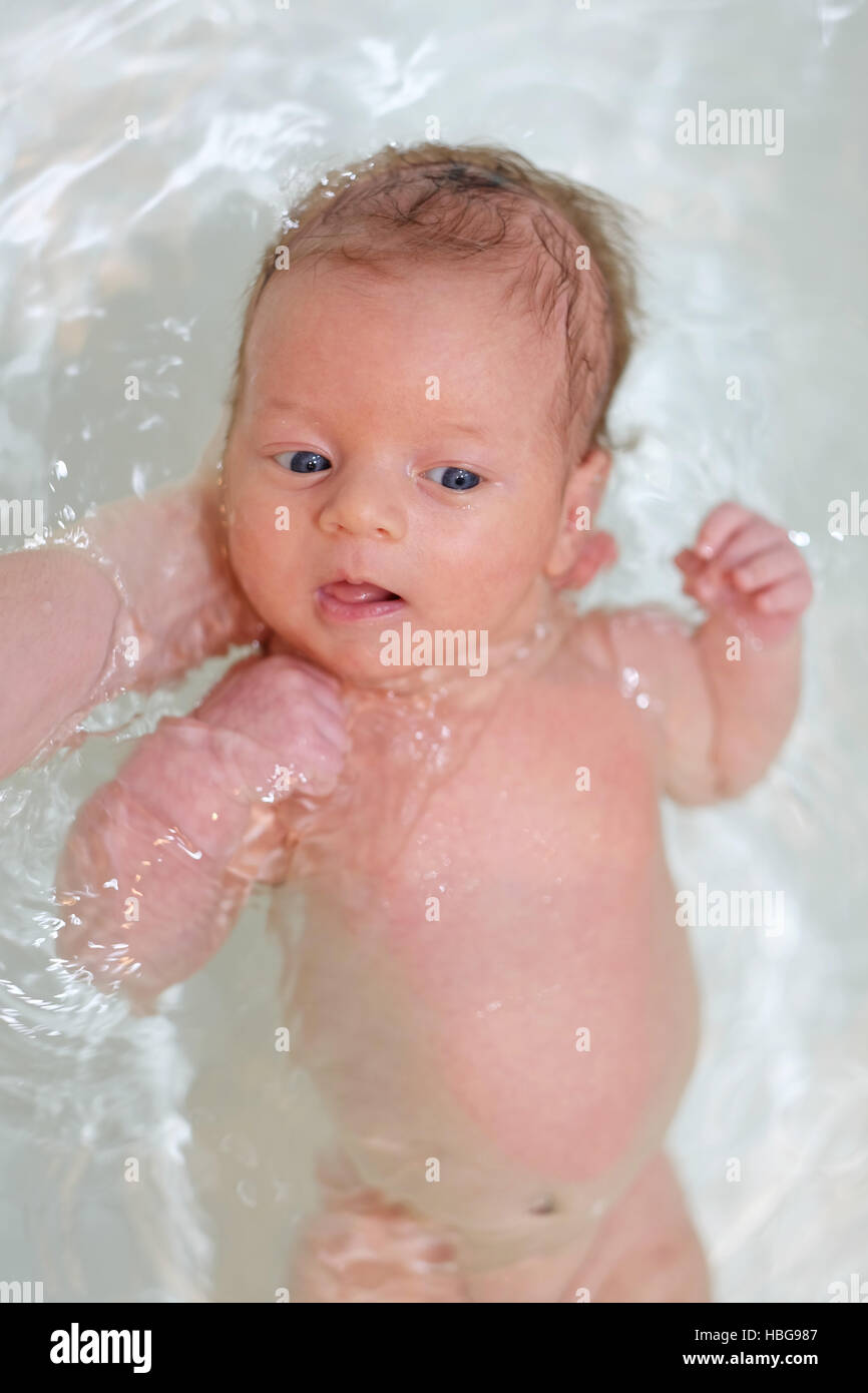 Newborn baby swimming in bath Stock Photo - Alamy