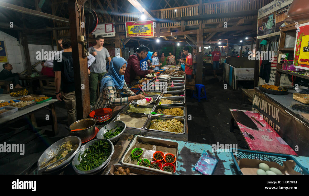 Indonesian woman taking food at booth, Food Market, Yogyakarta, Java, Indonesia Stock Photo
