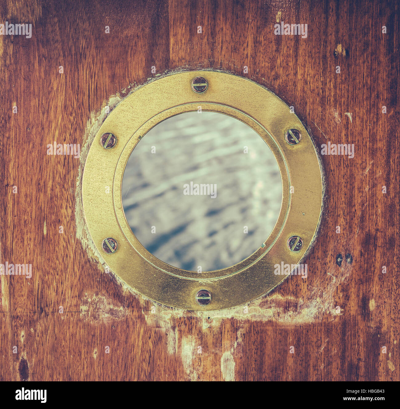Vintage Brass Porthole With Ocean Water Stock Photo