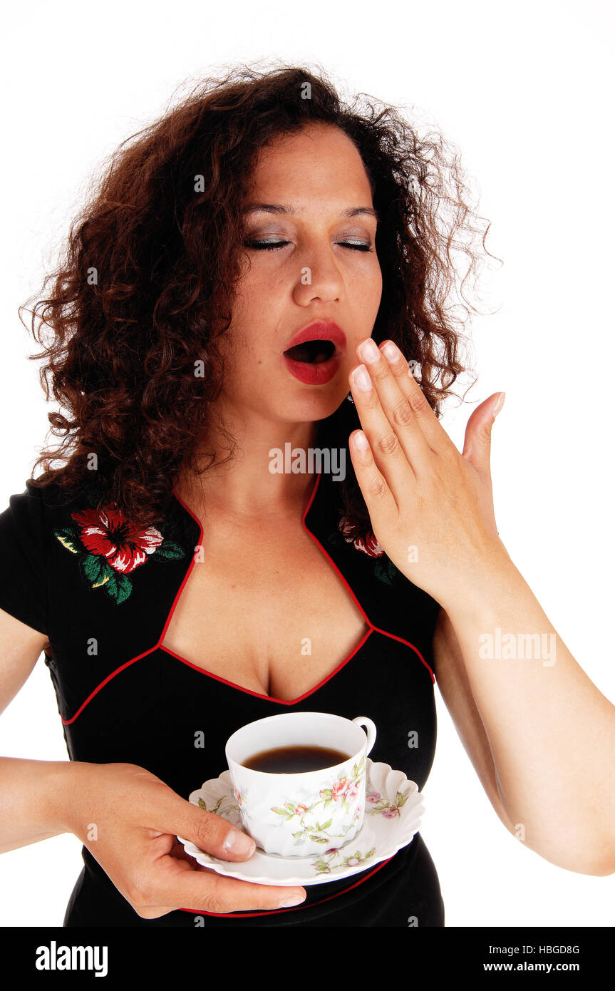 Tired woman holding coffee cup Stock Photo - Alamy