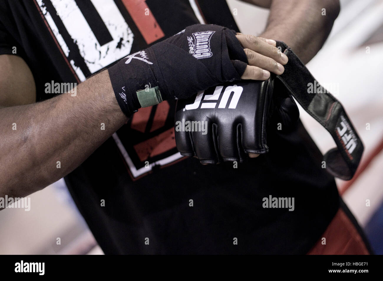 UFC fighter Alistair Overeem wraps his hands and puts on gloves during