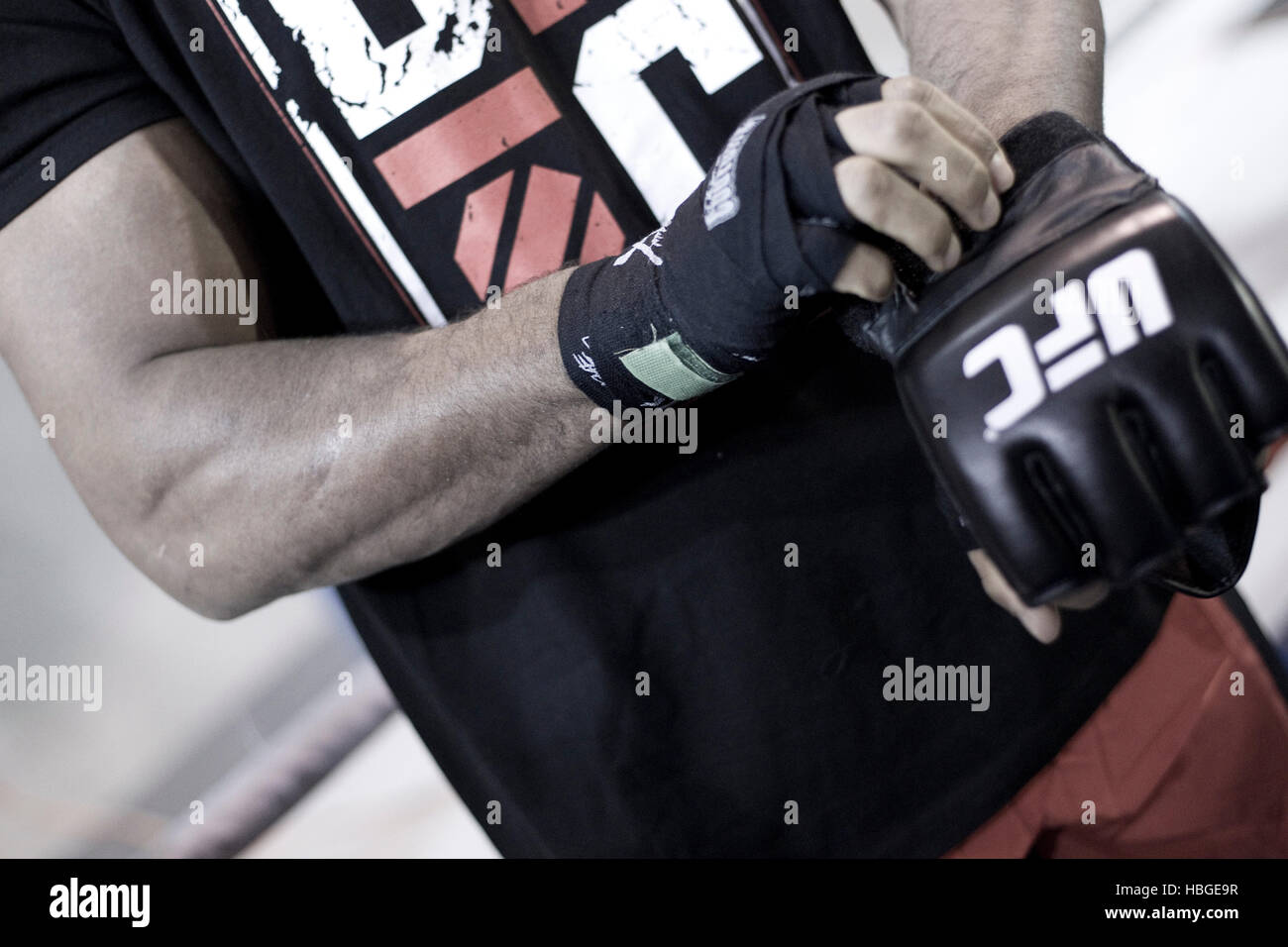 UFC fighter Alistair Overeem wraps his hands and puts on gloves during