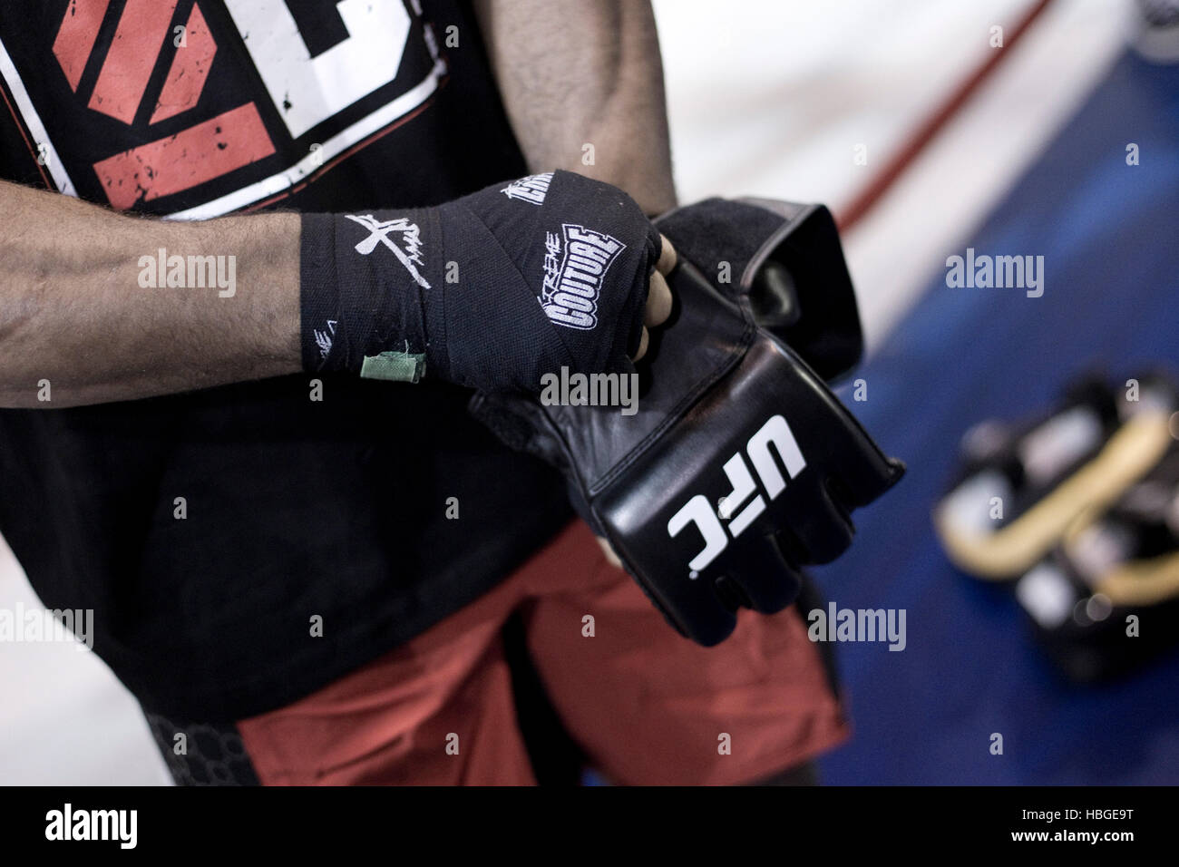UFC fighter Alistair Overeem wraps his hands and puts on gloves during a workout before UFC 141