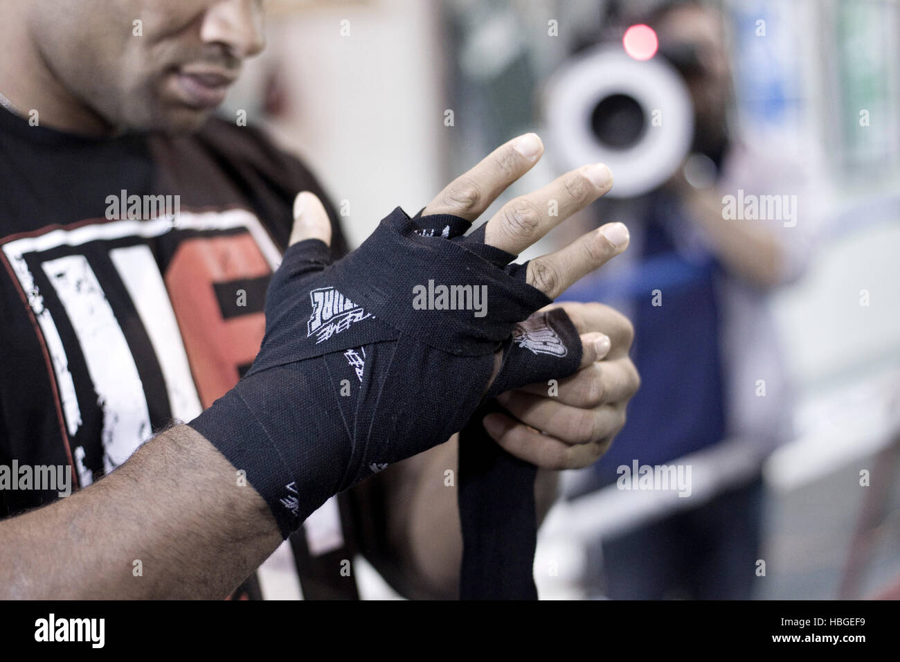 UFC fighter Alistair Overeem wraps his hands and puts on gloves during