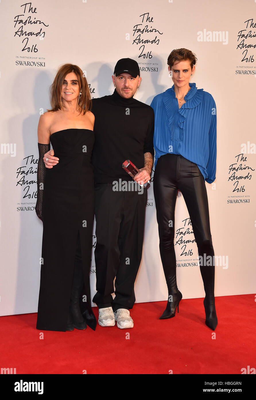 Demna Gvasalia and his award for International Ready To Wear Designer  alongside Carine Roitfeld and Stella Tennant in the press room during The  Fashion Awards 2016 at the Royal Albert Hall, London