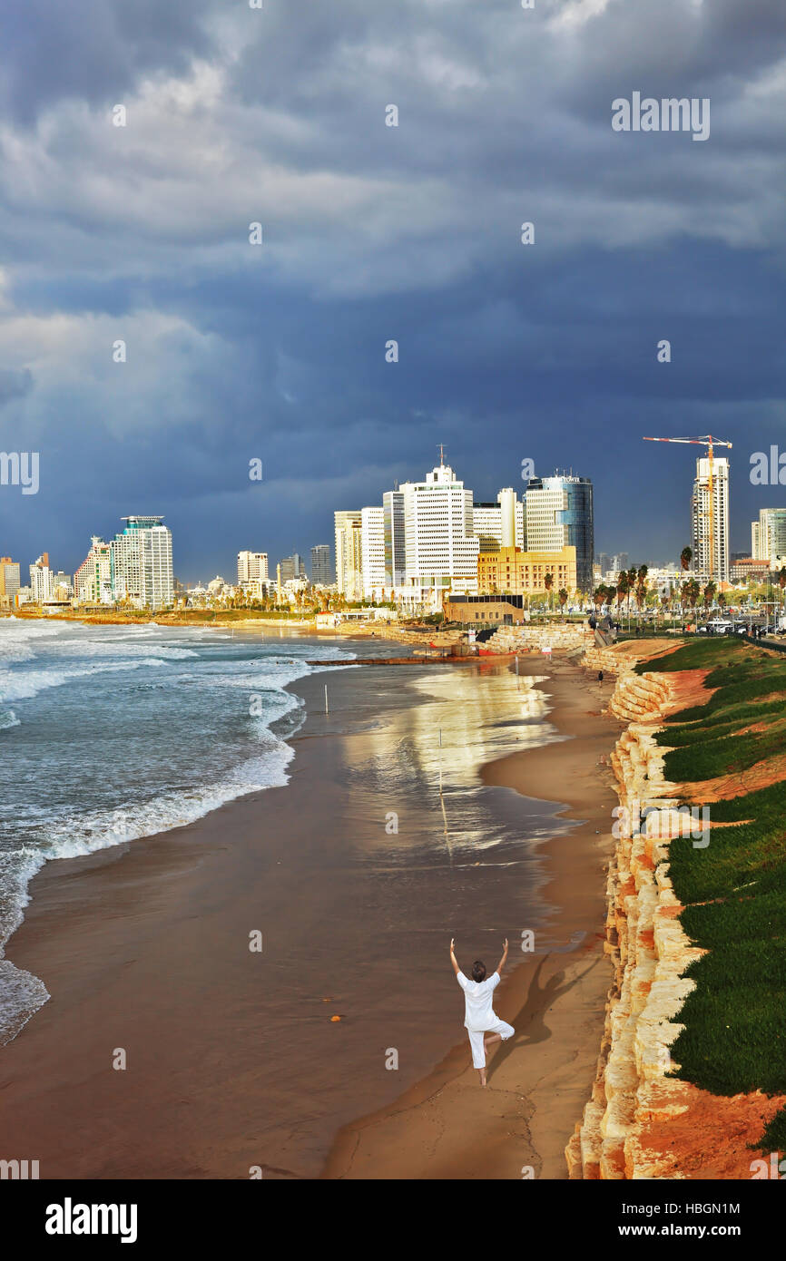 The woman performs yoga in Tel Aviv Stock Photo