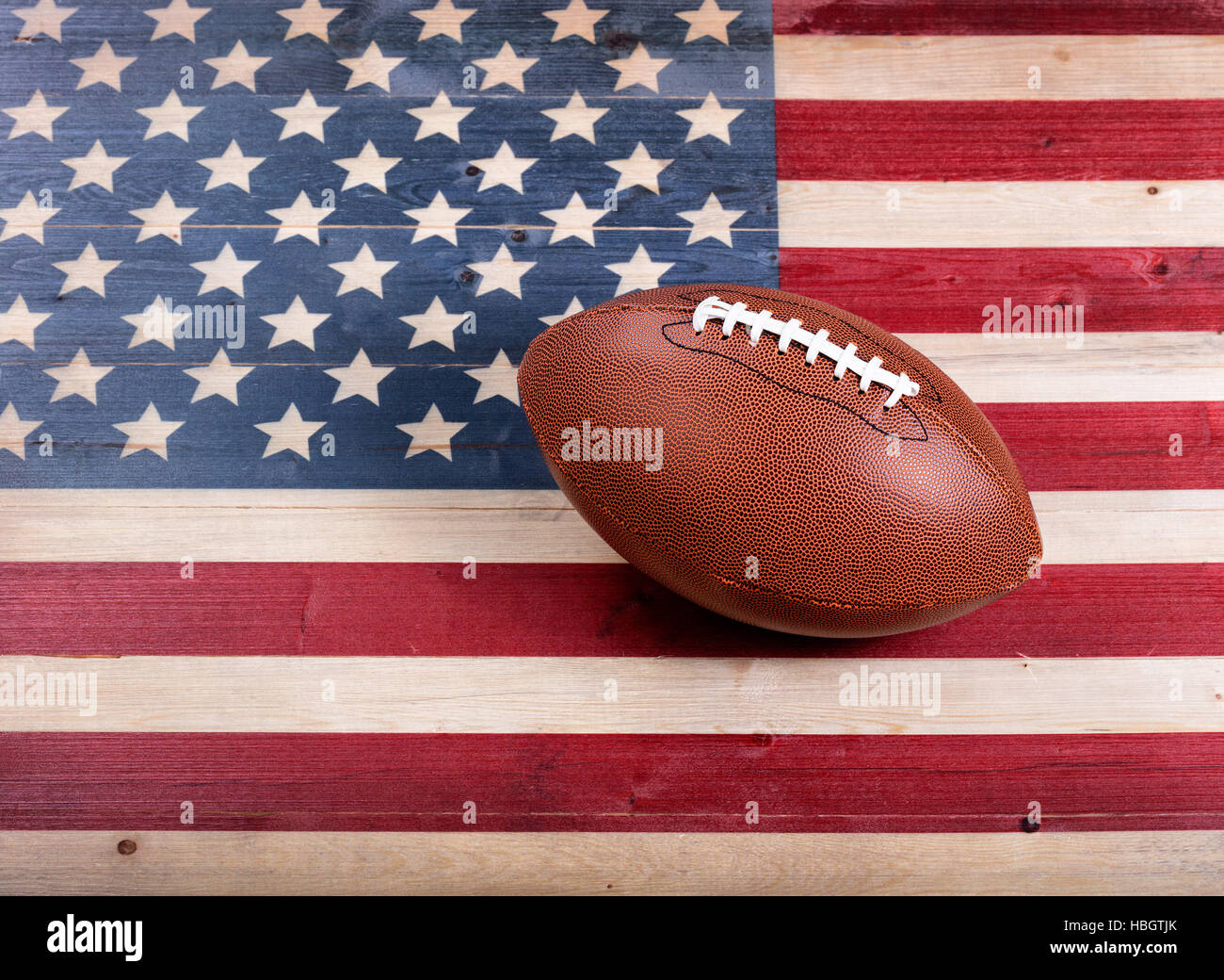American football on rustic wooden USA flag Stock Photo